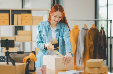 Online small business owners are packing their ordered products into the boxes for their customers based on the concept of online shopping - online shopping.