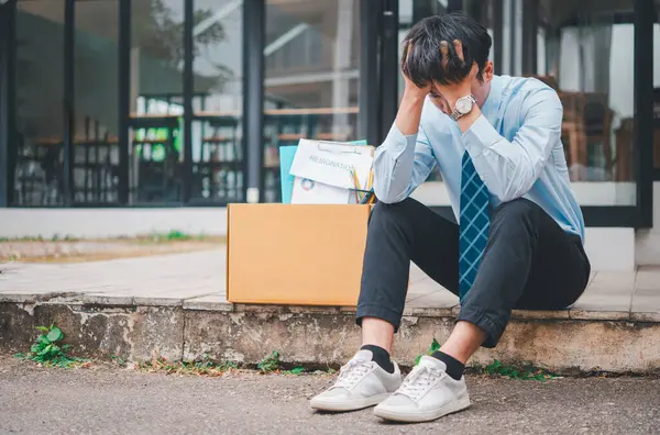 Young company employee stressed After resigning from work to find a new job , was fired by the company or when the employment contract expires, resulting in being unemployed