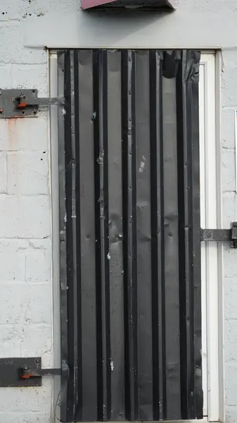 Secure grey door on a lock-up in an industrial property on the dockland of Barry.