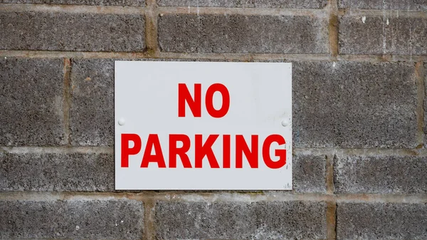 No parking signs on industrial units due to access requirements for industrial units. Red  letters on white background,