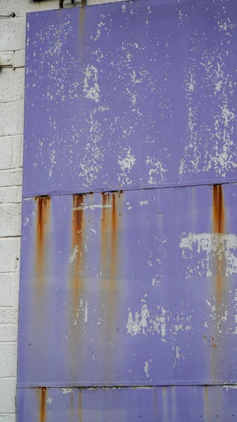 Purple door with large purple number 5 on an industrial unit