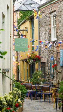 Tenby, Pembrokeshire Wales July 02 2024. Sergeant's Lane, a narrow, winding thoroughfare used historically for defensive and transport purposes. Now houses  busy and popular bars and a brewery.  clipart