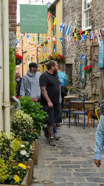 Stock image Tenby, Pembrokeshire Wales July 02 2024. Sergeant's Lane, a narrow, winding thoroughfare used historically for defensive and transport purposes. Now houses  busy and popular bars and a brewery. 