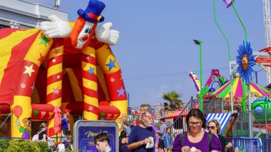 Barry Island, Vale of Glam, Wales, Aug 30 2024: The promenade fun park with its small children's rides is vibrant and busy. BBC Gavin and Stacey film crew started filming around that area on Sept 1st. clipart