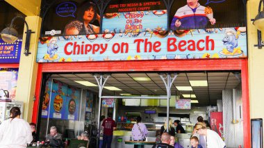 Barry Island, Vale of Glam, Wales Aug 30 2024. Fans of Gavin and Stacey visit the Chippy on the Beach in the western shelter, a fish and chip shop made famous by the TV series Gavin and Stacey.  clipart