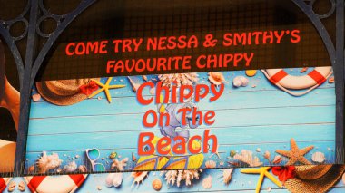 Barry Island, Vale of Glam, Wales Aug 30 2024. Signs and posters of Gavin and Stacey stars above chip shop at Barry Island known as Chippy on the Beach, made famous by the TV series Gavin and Stacey.  clipart