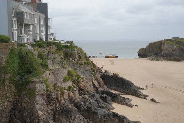 Tenby, Pembrokeshire, Wales - July 01 2024: The historic fort of St Catherine's Island is just offshore Castle Beach which lies between Castle Hill and East Rock in a deep cove.  clipart