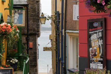 Tenby, Pembrokeshire, Wales - July 03 2024: Tenby is renowned for its alleyways and quaint narrow streets, many of which were used historically as shortcuts to move goods from the harbour to the town clipart