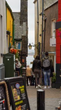 Tenby, Pembrokeshire, Wales - July 03 2024: Tenby is renowned for its alleyways and quaint narrow streets, many of which were used historically as shortcuts to move goods from the harbour to the town clipart