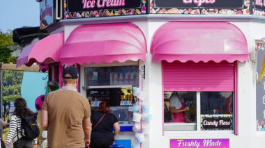 Barry Adası, Glamorgan, Galler Vadisi - 29 Ağustos 2024: Parlak renkli pembe ve beyaz bir dondurma salonu, büfesi, Barry Adası 'ndaki gezinti alanında, Gavin ve Stacey' nin evi. Ziyaretçiler arasında popüler