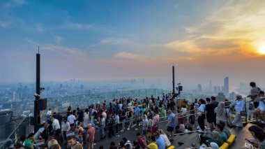 Bangkok, Thailand, 18 Jan 2025: Thailands tallest observatory deck at the Mahanakhon SkyWalk in Bangkok. The roof top bar stands at 314 m with spectacular views attract visitors of all nationalities clipart