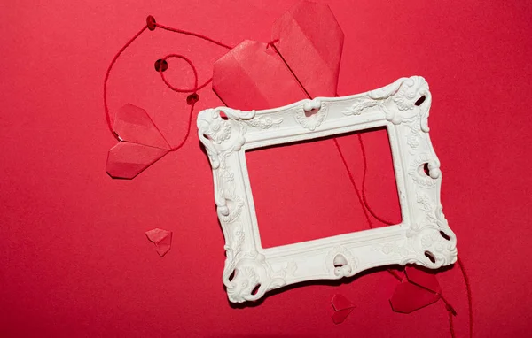 vintage white frame, hearts on red background for valentine's day