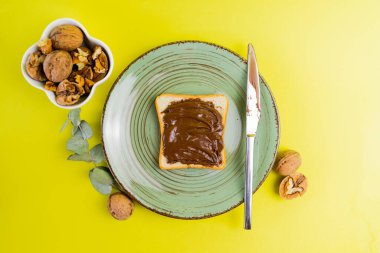 banana, almonds, walnut, almond nuts with raisins on a blue background and white