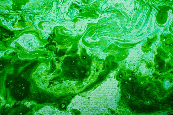 green and gold liquid abstract oil painting texture, modern background with space for text. colorful liquid design