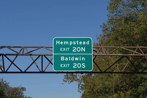 Exit sign on the Southern State Parkway on Long Island, New York for 20N Baldwin Road north toward Hempstead and 20S Grand Avenue south toward Baldwin