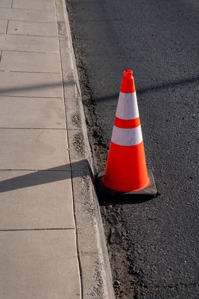 stock image orange traffic safety cone outdoor at the curb of the road