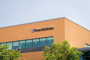 Somers Point, NJ - May 22, 2023: Penn Medicine sign and logo on the maternity care center building on the Shore Medical Center campus clipart