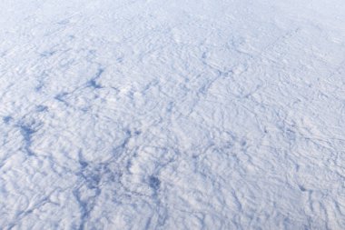 background showing the texture of clouds viewed from above, shot from an airplane window clipart