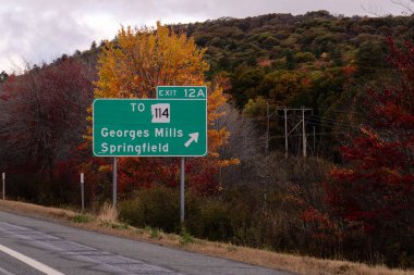 exit sign on Interstate 89 for  Exit 12A for NH-114 toward Georges Mills and Springfield, New Hampshire clipart