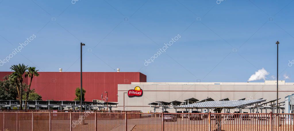 Casa Grande, AZ - March 29, 2025: At the Frito Lay factory, solar panels cover approximately two-thirds of the front parking lot, providing electricity as well as shading employees' cars.