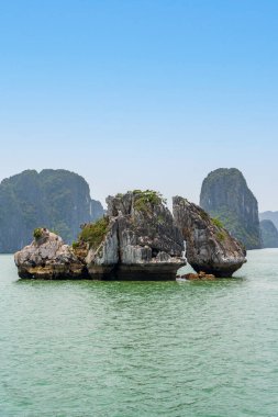 Fighting Cocks aka Trong Mai or Ga Choi Islets in Ha Long Bay, Quang Ninh, Vietnam. clipart