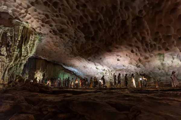 stock image Ha Long Bay, Vietnam - 28 Apr 2024: Tourists inside Surprise Grotto aka Hang Sung Sot in Ha Long Bay.