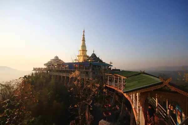 stock image LAMPHUN, THAILAND -February 18, 2018: Heritage Golden temple and naga on lightpole located on the mountain in the northern of Thailand