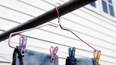 Renkli elbise klipsleri ve çamaşır askısı dışarıda asılı.