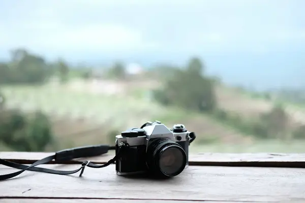 Vintage Film camera on wooden terrace with natural background