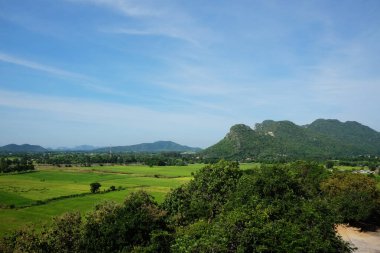 Landscape valley of mountain and greenery paddy rice field in Thailand clipart