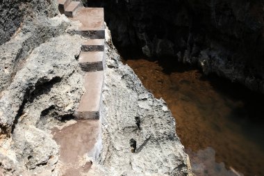 Antik beton merdivenler ve Endonezya 'nın Bali ve Nehrinde kayalık uçurumlarda yürüyüş yolu ve taş dağ