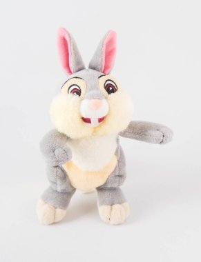 Pembe kulaklı peluş tavşan. Beyaz arka planda çocuklar için yumuşak bir oyuncak.