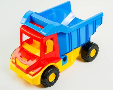 Children's toy multi-colored plastic truck on a white background.