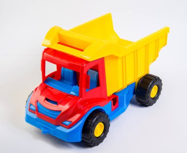 Children's toy multi-colored plastic truck on a white background.