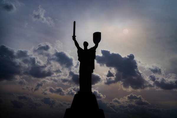 Kyiv, Ukraine. February 20, 2022 The silhouette of the Motherland monument, a statue against the disturbing sky. Two days before the start of the Russian-Ukrainian war. The symbol of victory.