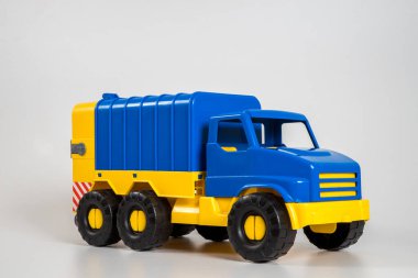 Beyaz arka planda çok renkli plastik çocuk arabaları..