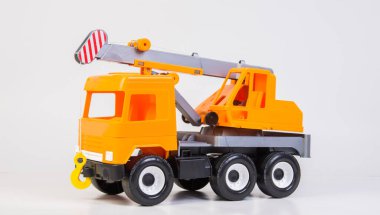 Lift truck. Multi-colored children's toys plastic trucks on a white background.