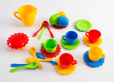 Beyaz arka planda, çocukların çok renkli plastik sofra takımı..