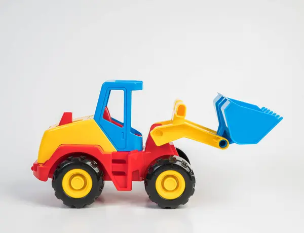 Plastic toy models of construction vehicles. Bulldozer.