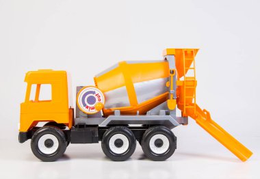 Concrete truck. Multi-colored children's toys plastic trucks on a white background.