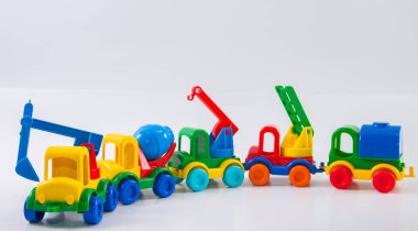 Plastik oyuncak, beyaz arka planda çok renkli bir kamyon. İnşaat ekipmanları grubu.