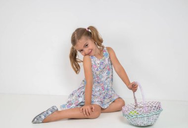 Girl in dress with tails on head on white background.Beautiful wicker basket. clipart