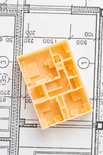 Top view of first floor of architectural 3D model of the house interior with furniture, doors, staircase printed on a 3D printer with orange filament by SLA technology. Example of apartment layouts