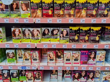 Berlin, Germany - January 12, 2023: View to a shelf with packs of hair dye in a drugstore.