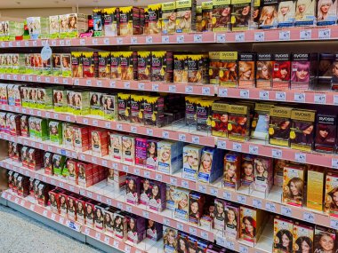 Berlin, Germany - January 12, 2023: View to a shelf with packs of hair dye in a drugstore.