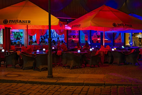 stock image Berlin, Germany - August 3, 2019: Night shot of a colorfully illuminated restaurant in downtown Berlin.