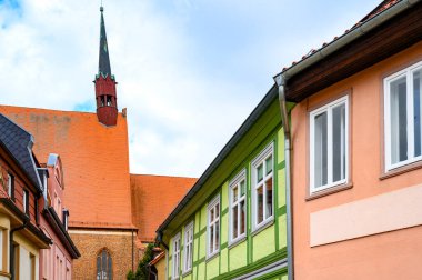 View to facades of historic buildings in Salzwedel, Germany, under a blue sky.