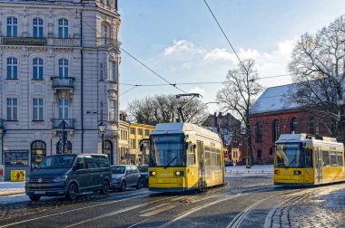 Berlin, Germany - January 19, 2024: Street scene in Berlin-Koepenick with two streetcars in front of historic buildings. clipart