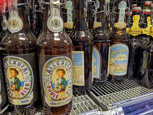 Berlin, Almanya - 19 Ekim 2021: Süpermarkette bira şişeleriyle dolu bir rafa bakın.