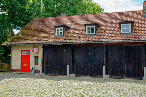 stock image Building of a historic volunteer fire department in Berlin, Germany. You can see the entrance to the fire station with the wooden gates.